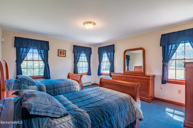a bathroom with a sink mirror and a window