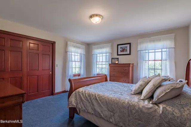 a room with a baby bed furniture and a dresser
