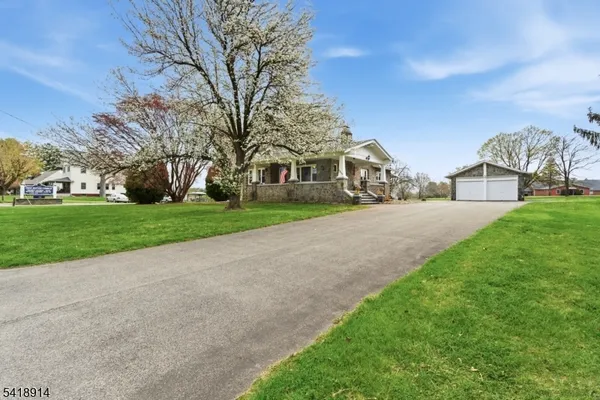 a view of a house with a tree in a yard