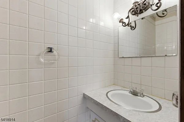 a view of a house with a big yard potted plants and large tree