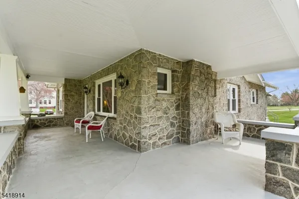 a aerial view of a house with a yard basket ball court and outdoor seating