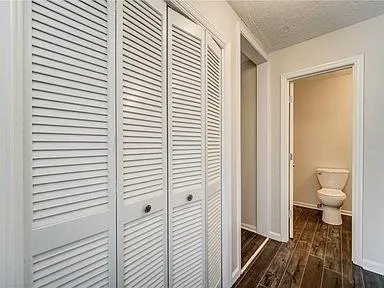 a bathroom with a granite countertop next to a white toilet