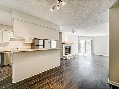 a view of kitchen with furniture and wooden floor