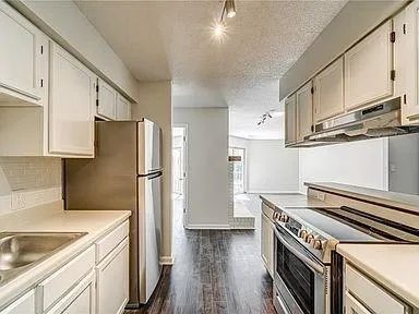 a kitchen with a refrigerator sink and stove