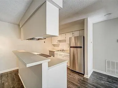 a kitchen with cabinets and stainless steel appliances