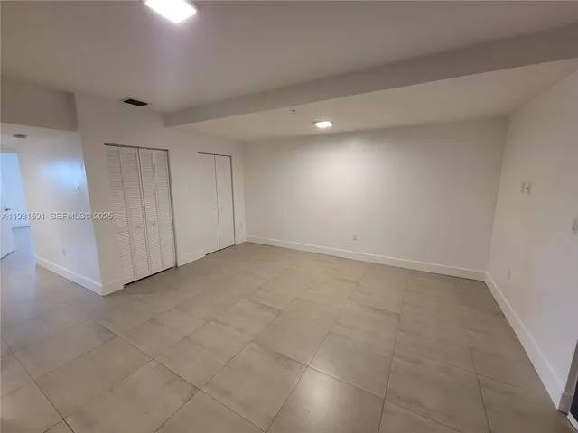 an empty room with a mirror