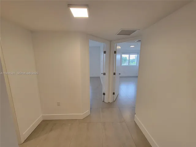 an empty room with a empty space and windows