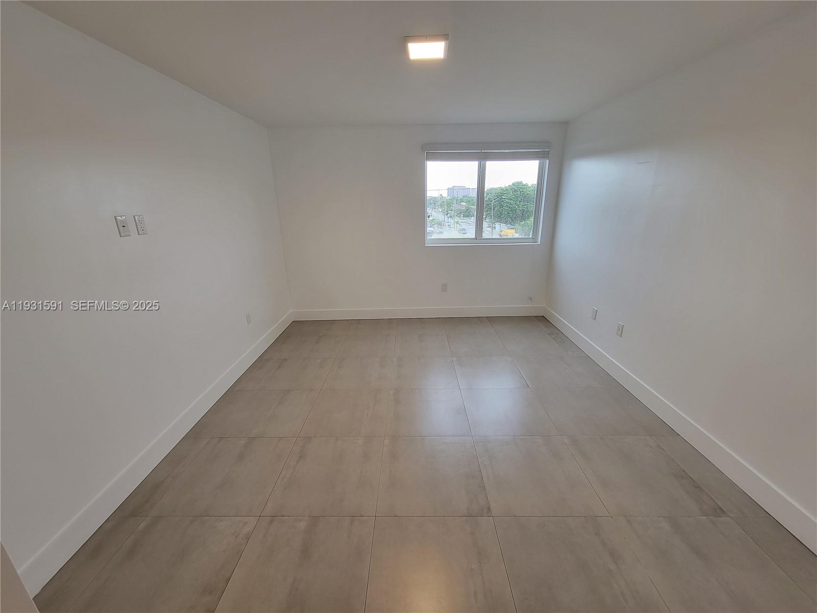 6001 West Flagler Street, Unit 302 Miami, FL 33144 - Photo 7 of 12 an empty room with a window
