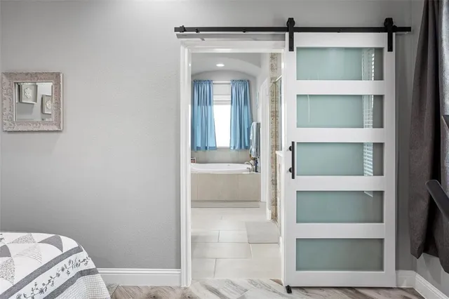 a bathroom with a tub a sink and a window