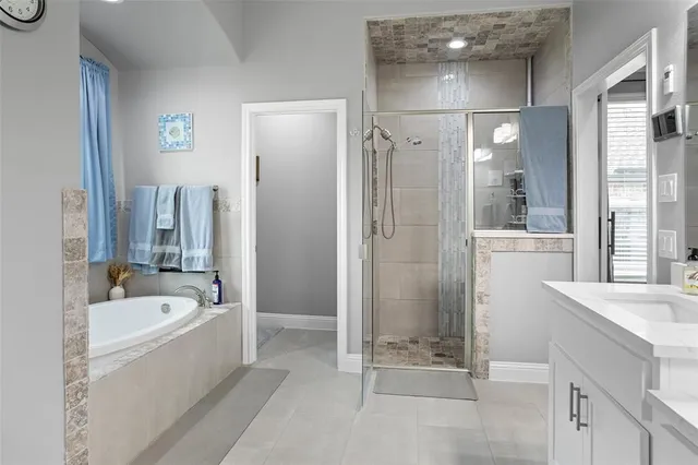a bathroom with a double vanity sink mirror and shower