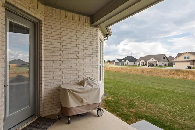 a view of a balcony with chair and a floor to ceiling window
