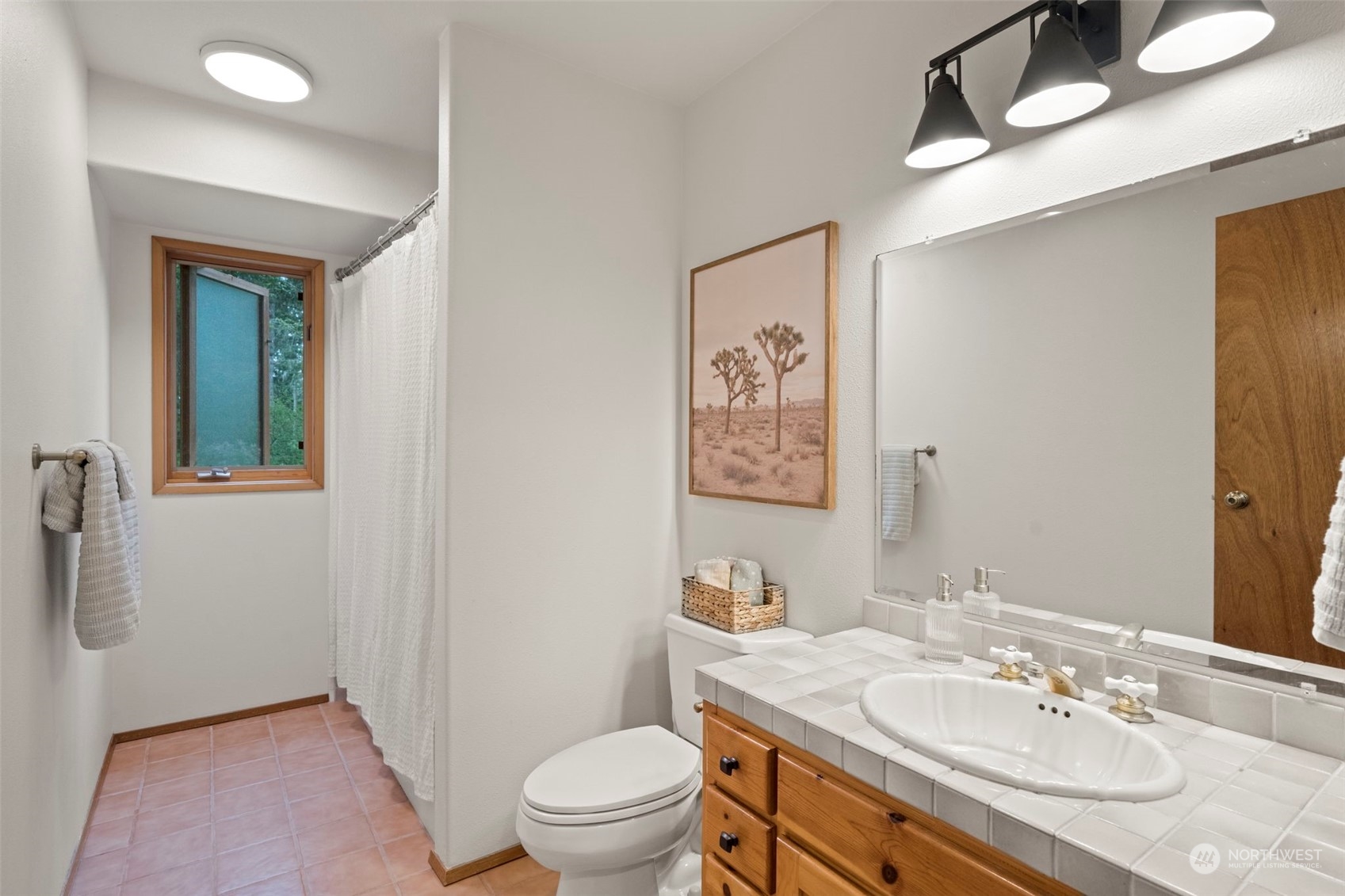 835 Hyak Way Fox Island, WA 98333 - Photo 12 of 38 a bathroom with a granite countertop sink toilet and a mirror