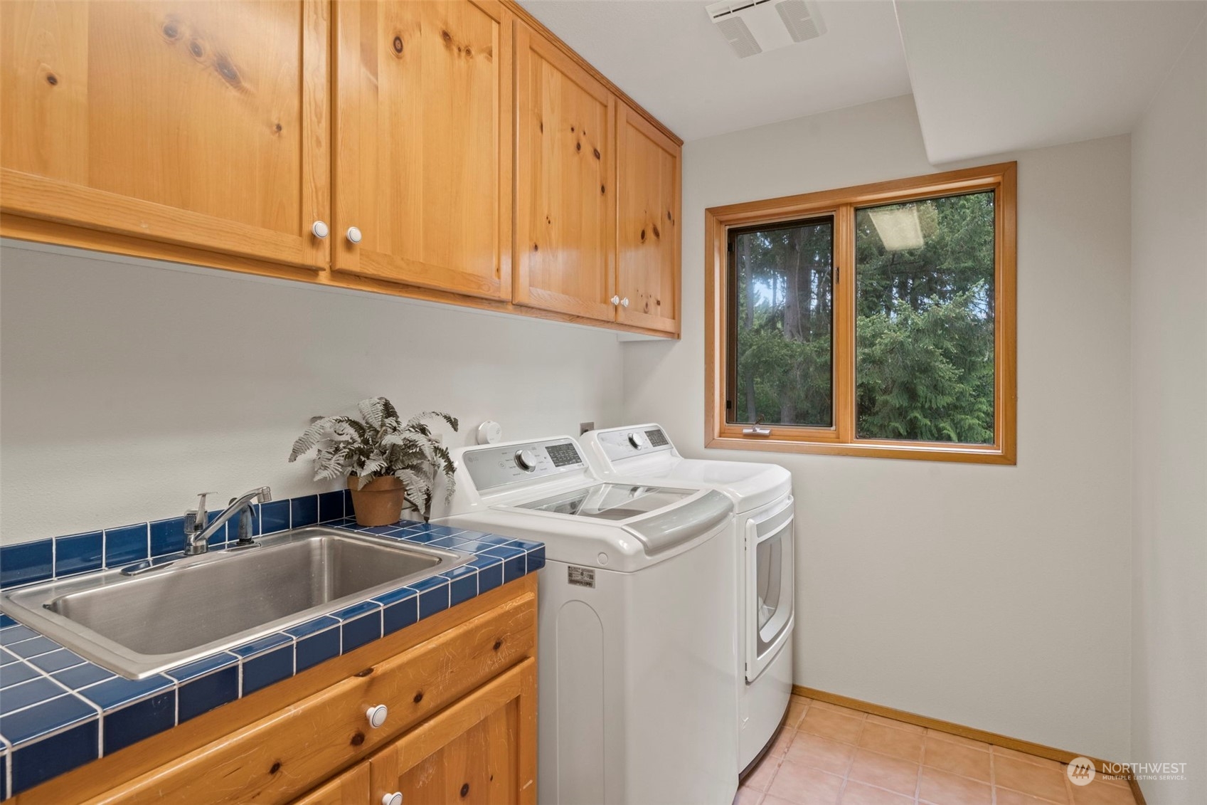 835 Hyak Way Fox Island, WA 98333 - Photo 14 of 38 a utility room with sink dryer and washer
