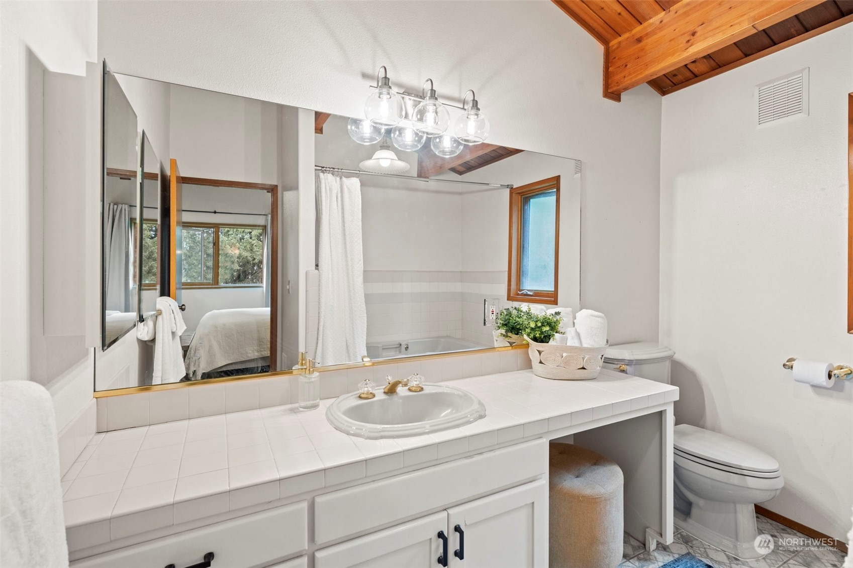 835 Hyak Way Fox Island, WA 98333 - Photo 17 of 38 a bathroom with a sink and a mirror