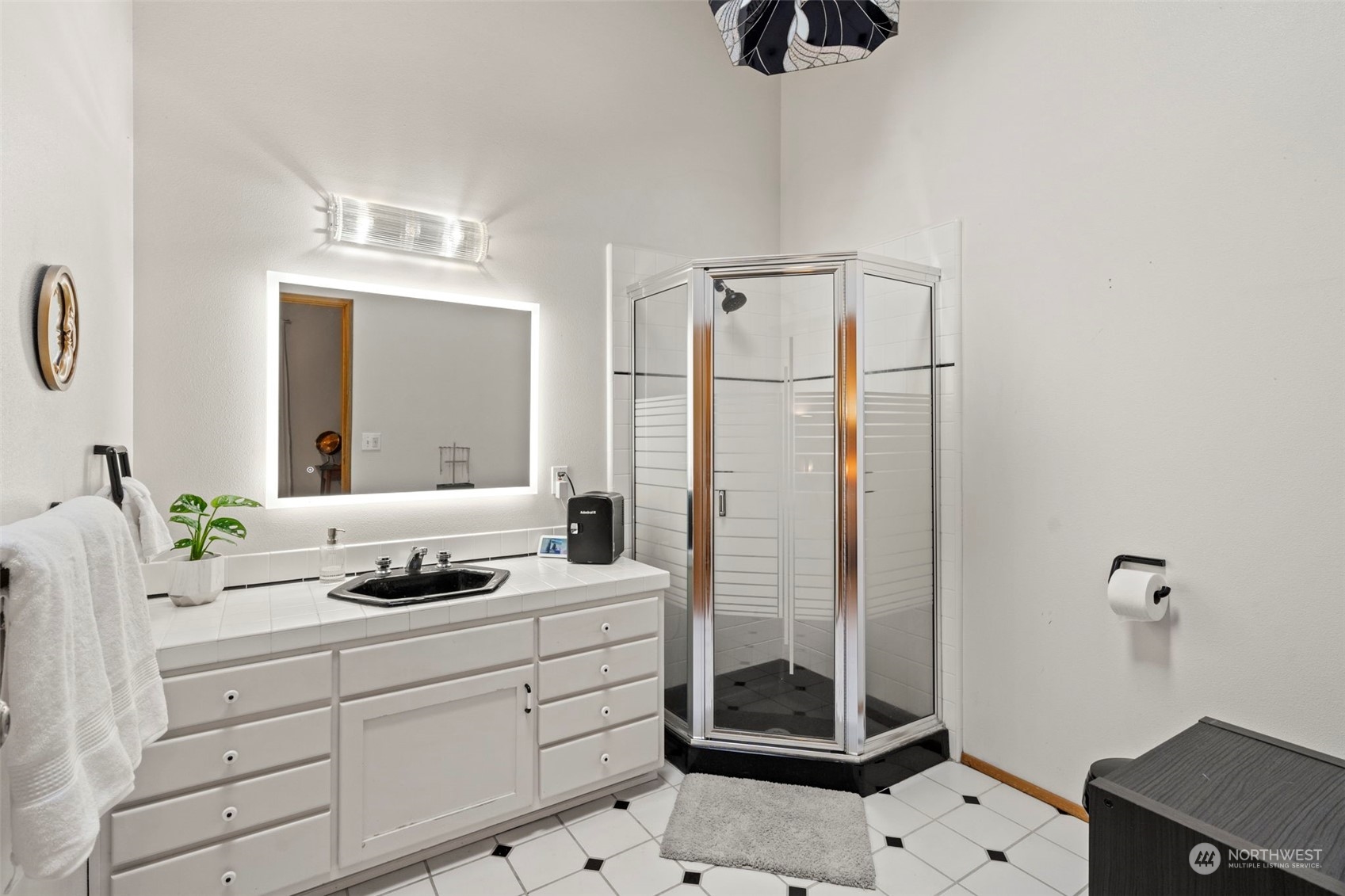 835 Hyak Way Fox Island, WA 98333 - Photo 19 of 38 a bathroom with a double vanity sink a mirror and shower