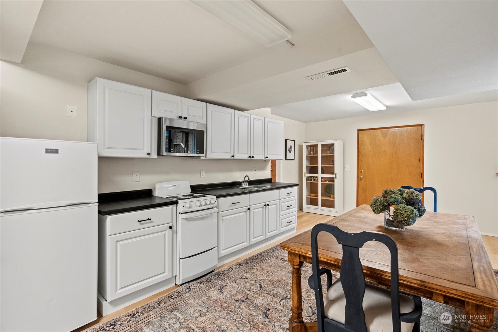 835 Hyak Way Fox Island, WA 98333 - Photo 25 of 38 a kitchen with white cabinets and stainless steel appliances