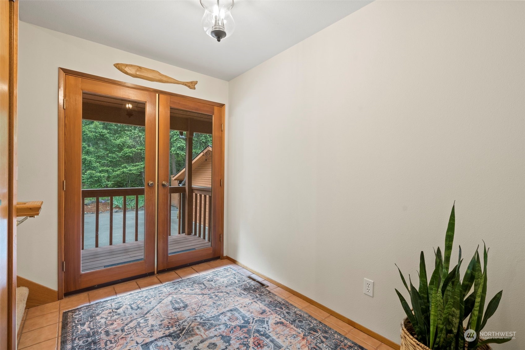 835 Hyak Way Fox Island, WA 98333 - Photo 27 of 38 a view of a room with a large window and wooden floor