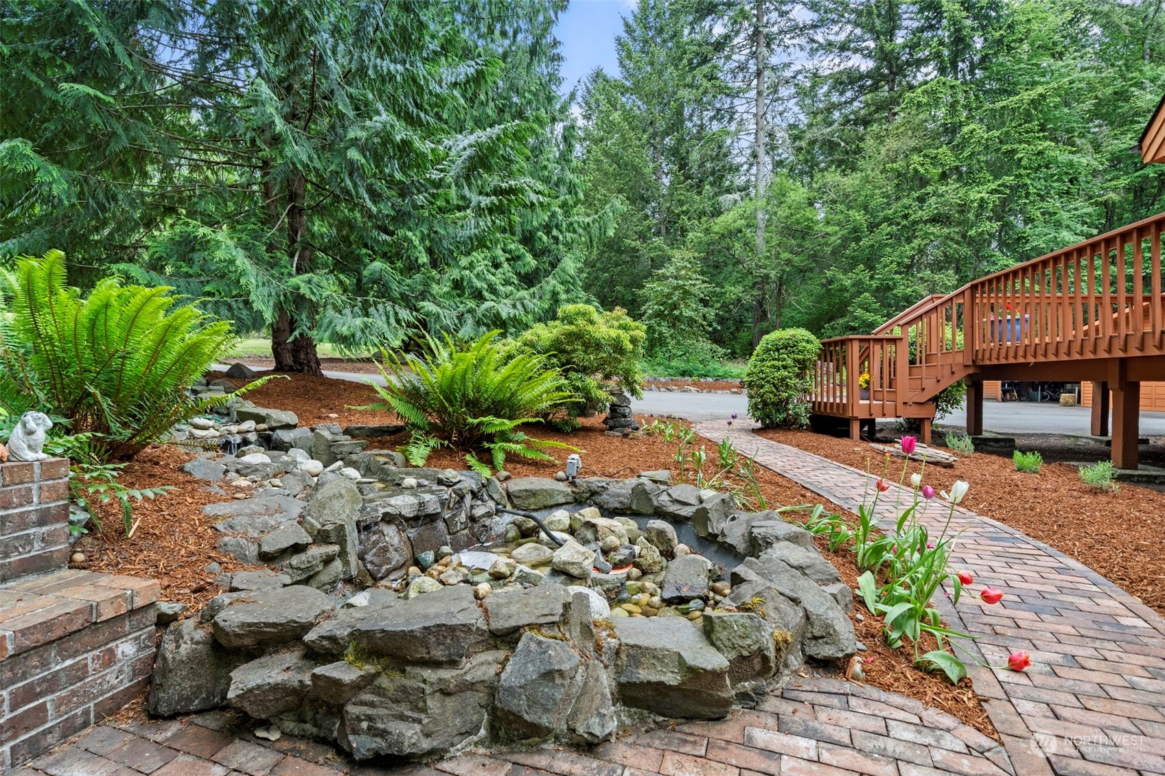 835 Hyak Way Fox Island, WA 98333 - Photo 31 of 38 a view of a garden with plants and large trees