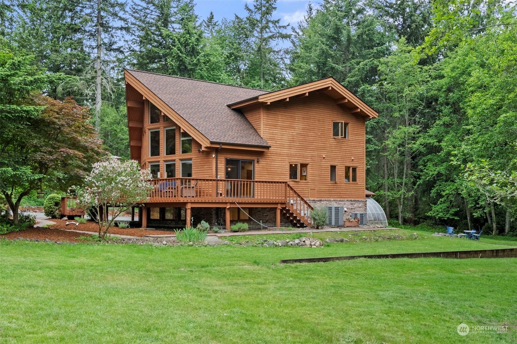 835 Hyak Way Fox Island, WA 98333 - Photo 32 of 38 a aerial view of a house with a yard table and chairs