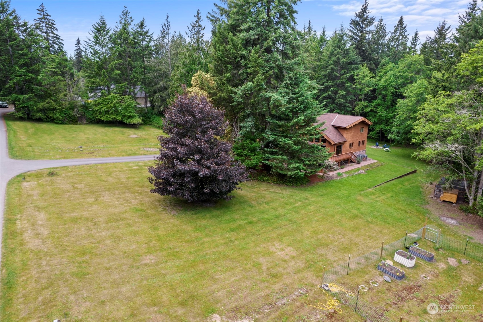 835 Hyak Way Fox Island, WA 98333 - Photo 35 of 38 a backyard of a house with lots of green space
