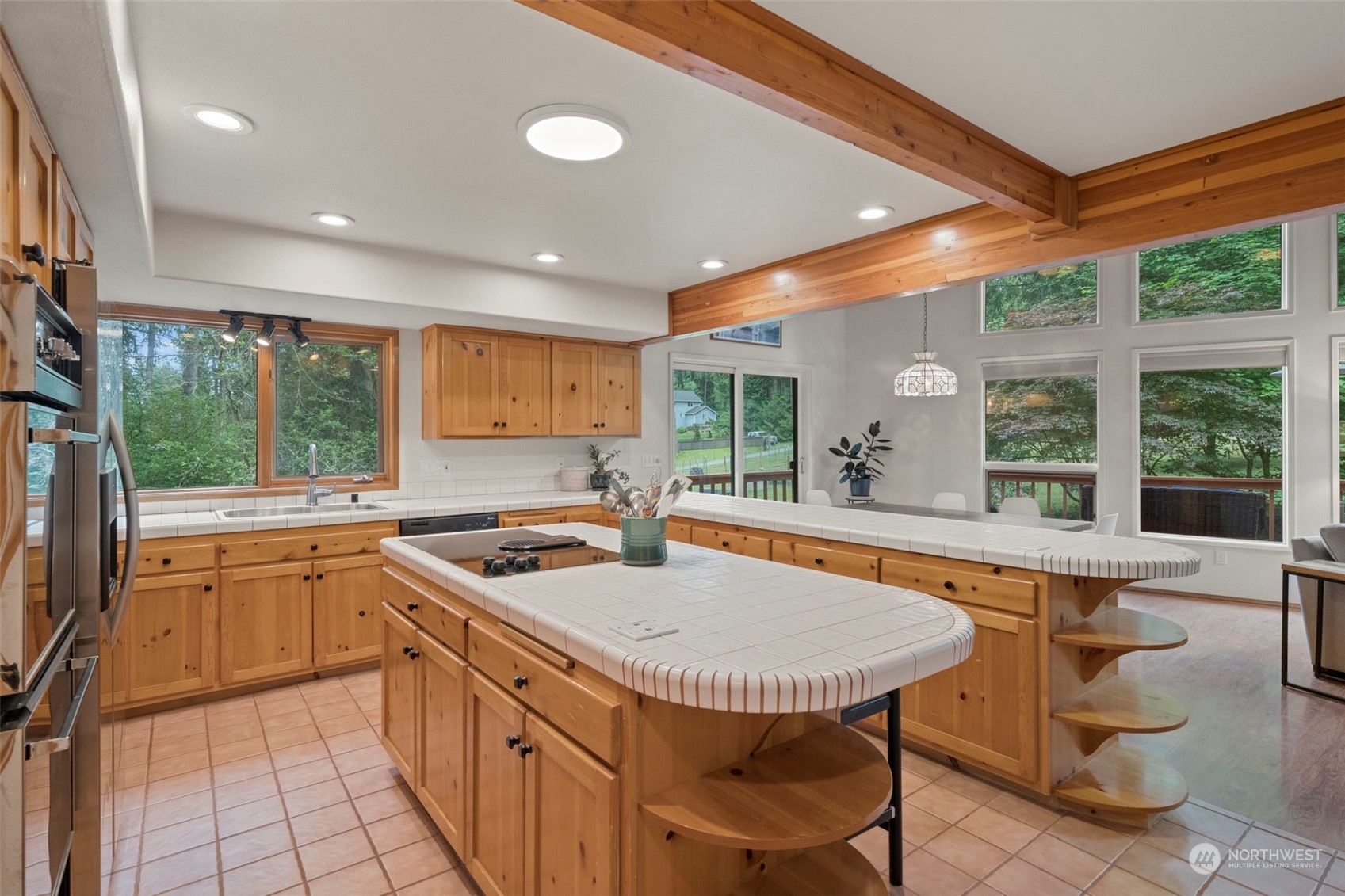 835 Hyak Way Fox Island, WA 98333 - Photo 6 of 38 a kitchen with stainless steel appliances granite countertop sink stove and refrigerator