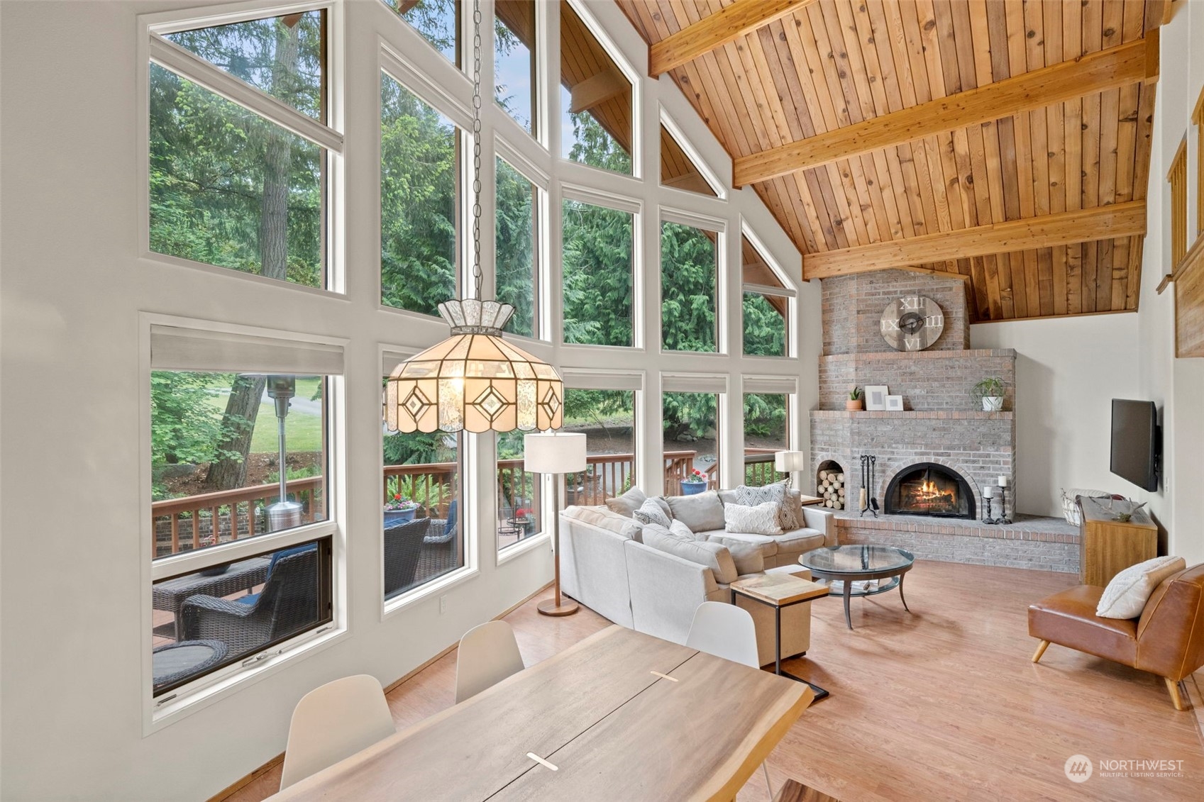 835 Hyak Way Fox Island, WA 98333 - Photo 9 of 38 a living room with furniture a fireplace and a large window