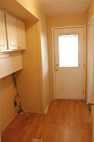 a view of a room with rack on the wall and a window