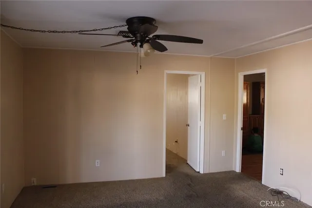 a view of a room with a ceiling fan