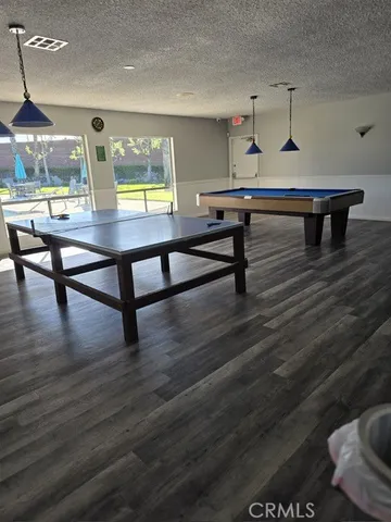 a view of a patio with a table chairs and a backyard
