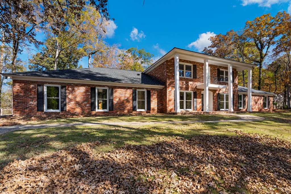 6758 Standing Boy Road Columbus, GA 31904 - Photo 2 of 46 a front view of a house with a yard table and chairs
