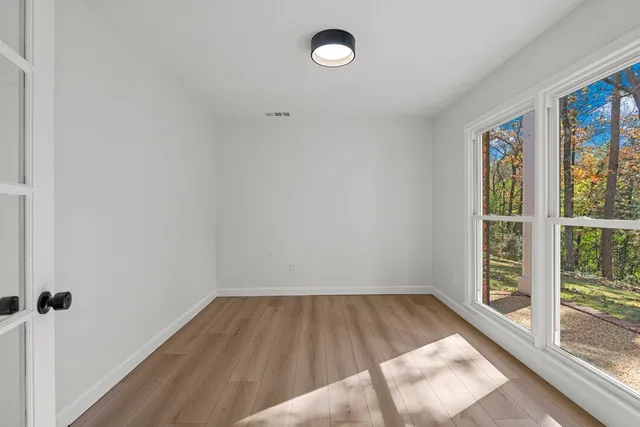 a view of room with window and hardwood floor