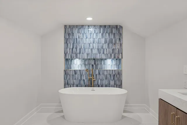 a bathroom with a bathtub and shower