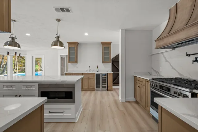 a kitchen with granite countertop a stove and a sink