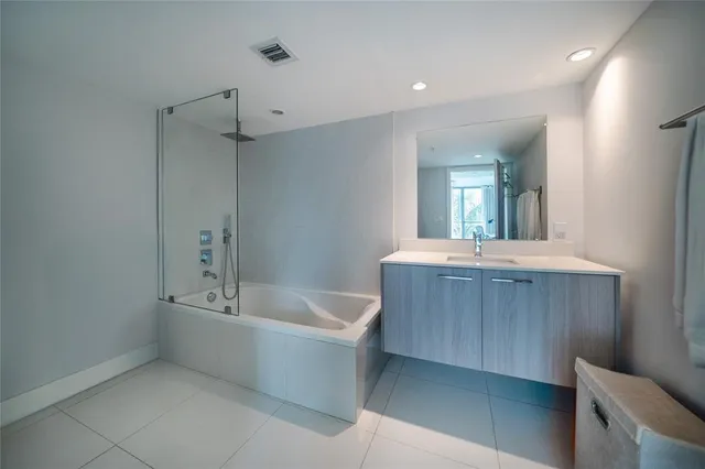 a living room with furniture a rug and a table