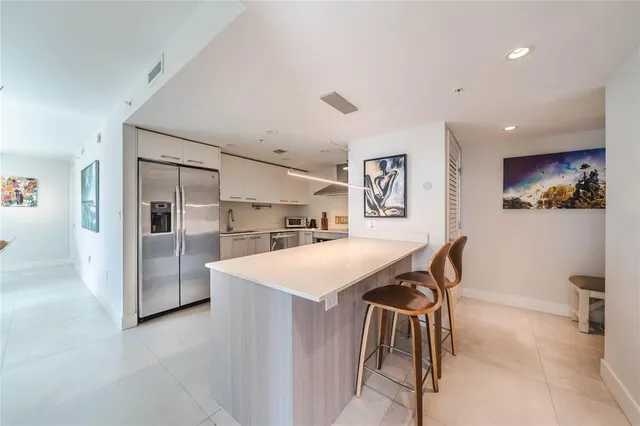 a kitchen with stainless steel appliances a stove and more cabinets