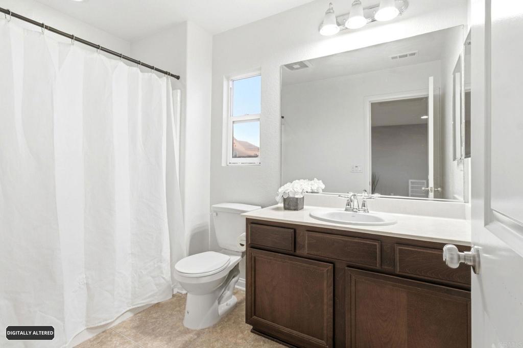 1508 Carpinteria Street Chula Vista, CA 91913 - Photo 23 of 39 a bathroom with a toilet a sink and a mirror