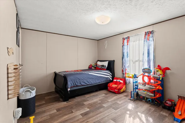 a bedroom with a bed and a window