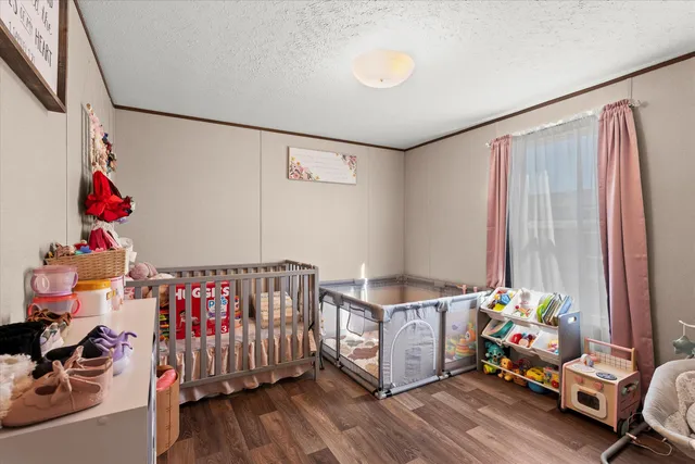 a bedroom with furniture and a baby crib