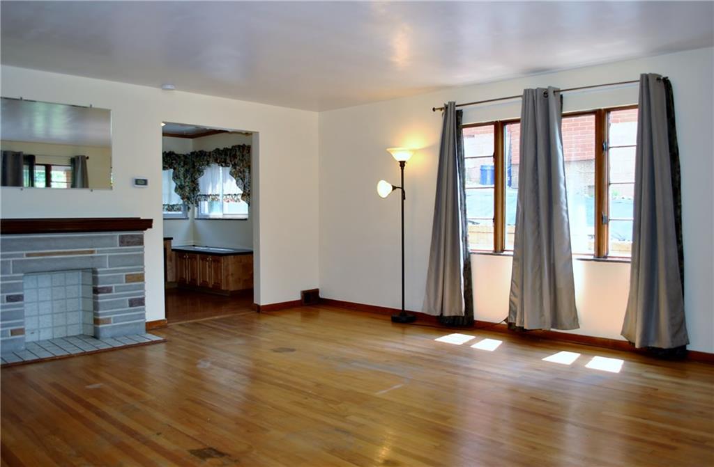 228 Bascom Avenue Pittsburgh, PA 15214 - Photo 2 of 24 Huge living room featuring hardwood floors, large windows, and decorative fireplace provide plenty of space to relax and unwind.