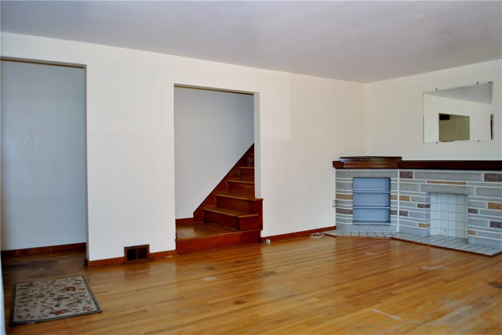 228 Bascom Avenue Pittsburgh, PA 15214 - Photo 13 of 24 Living room with small entry and coat closet, with hardwood stairs leading to second floor!