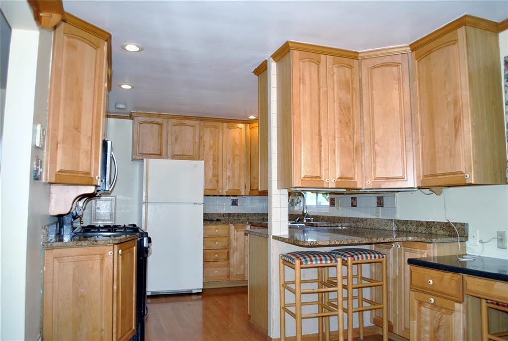 228 Bascom Avenue Pittsburgh, PA 15214 - Photo 3 of 24 Wow! Just Wow! Updated gourmet kitchen offers tons of cabinet space, granite counter tops, recessed lighting, views of the backyard, all appliances, bar seating area, open to dining room! What's for dinner?