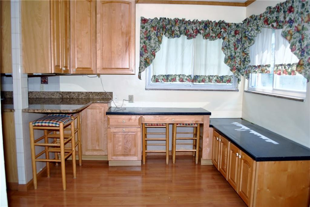 228 Bascom Avenue Pittsburgh, PA 15214 - Photo 4 of 24 Dining room offers 2 large windows, bar counter, more cabinets, desk area, and access to the side yard.