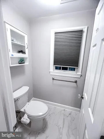 a white toilet sitting next to a bathroom sink