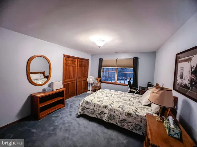 a bedroom with bed and a window