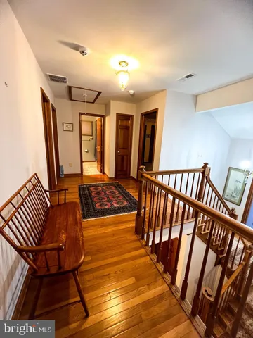 a living room with chairs and a rug