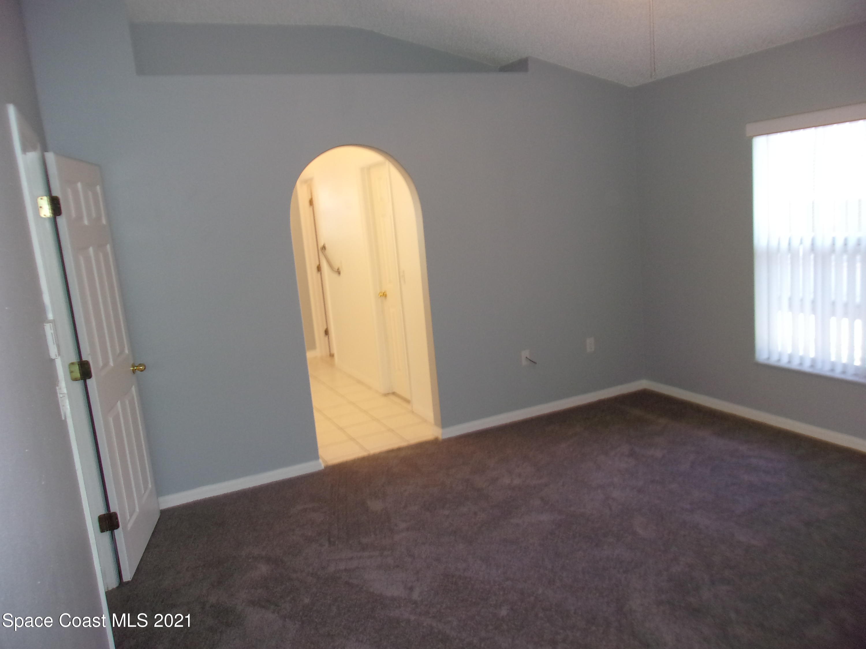 3908 Upmann Drive Rockledge, FL 32955 - Photo 29 of 35 an empty room with windows