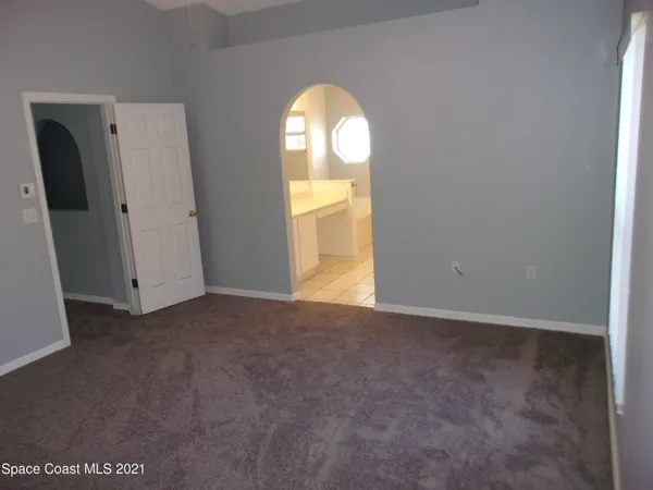 a bathroom with a tub and a window