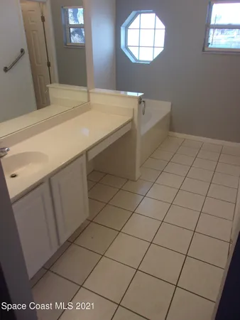 a white toilet sitting next to a shower