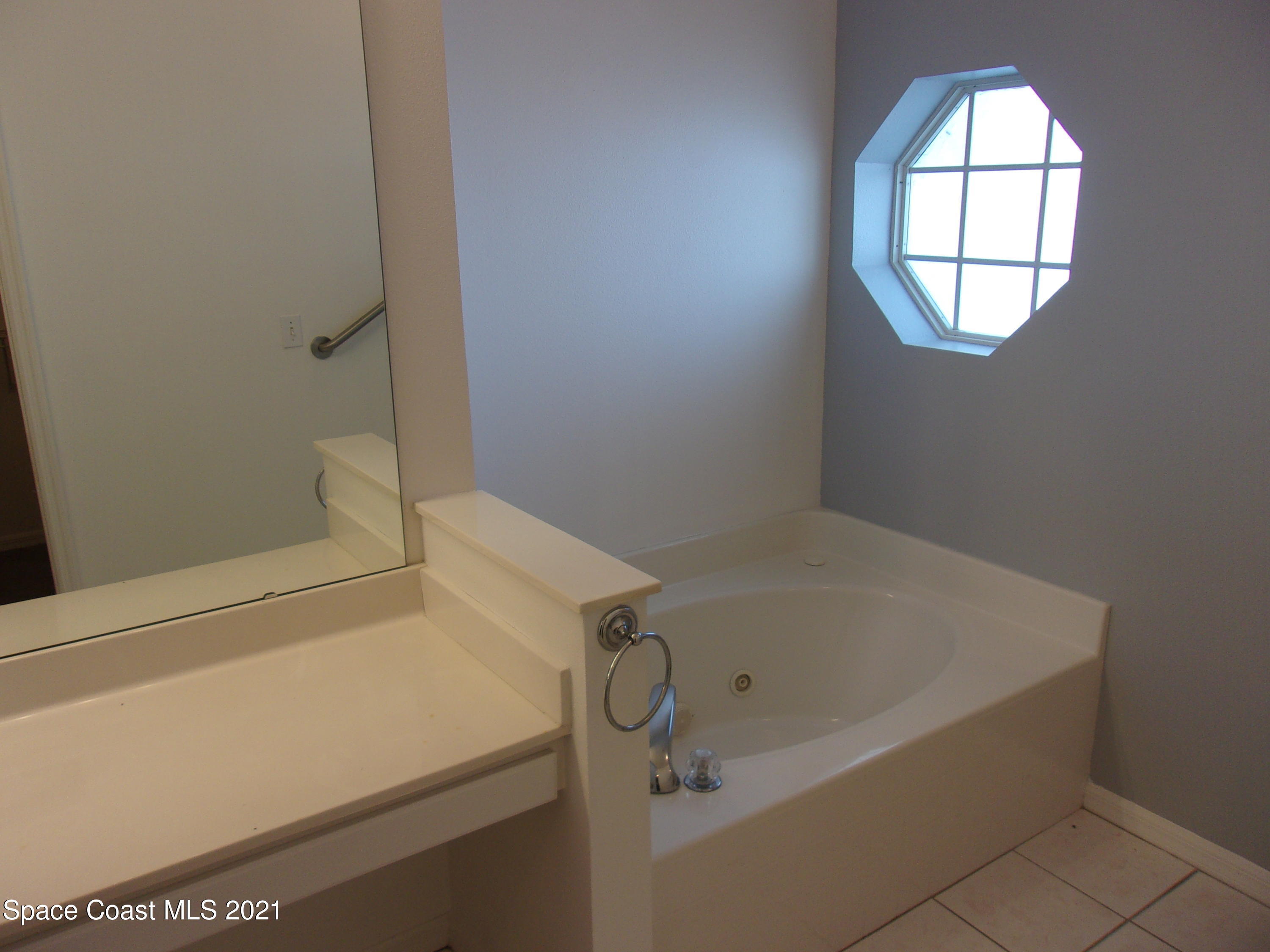 3908 Upmann Drive Rockledge, FL 32955 - Photo 33 of 35 a bathroom with a tub and a window