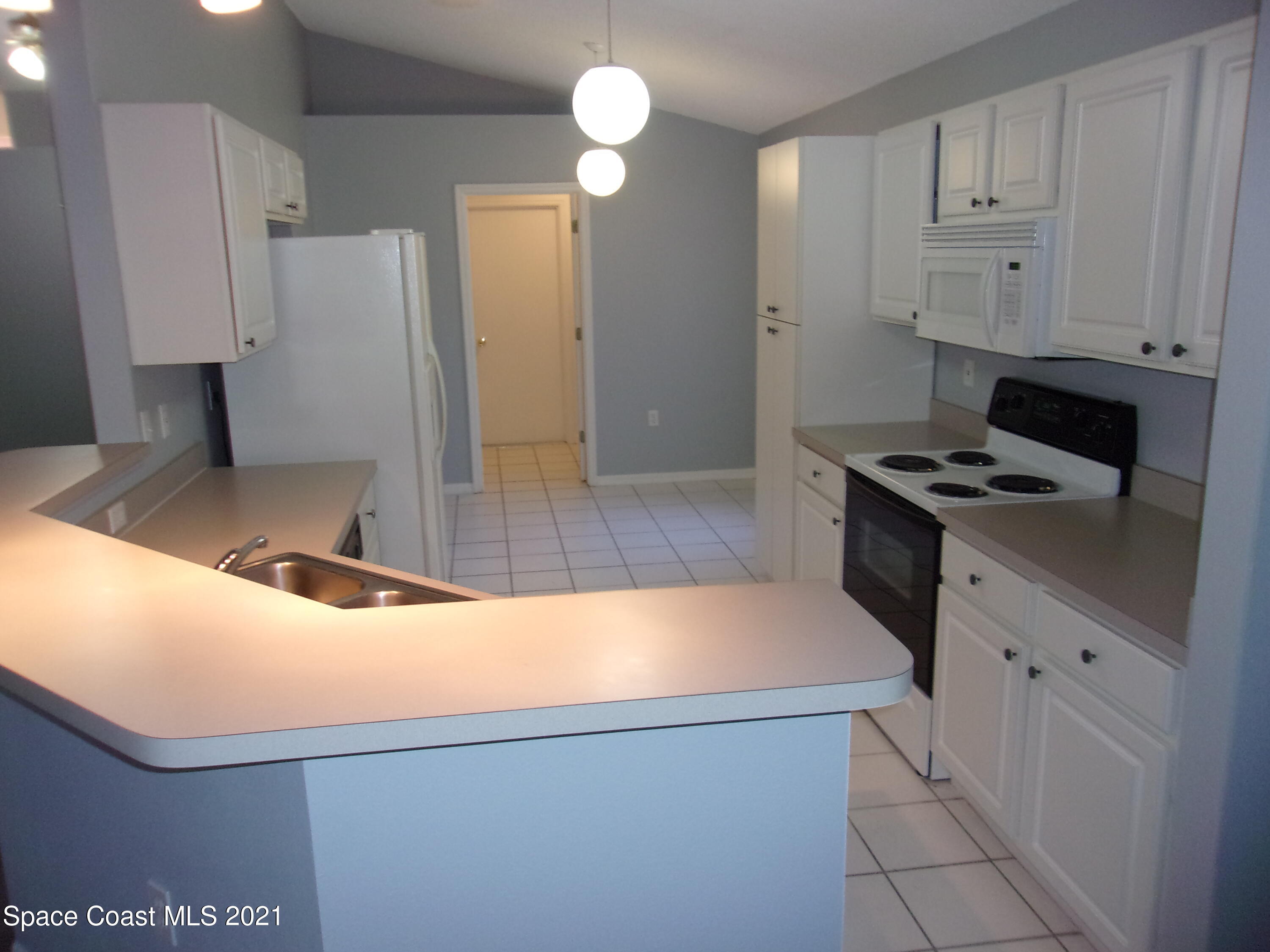 3908 Upmann Drive Rockledge, FL 32955 - Photo 10 of 35 a kitchen with stainless steel appliances granite countertop a sink and a stove